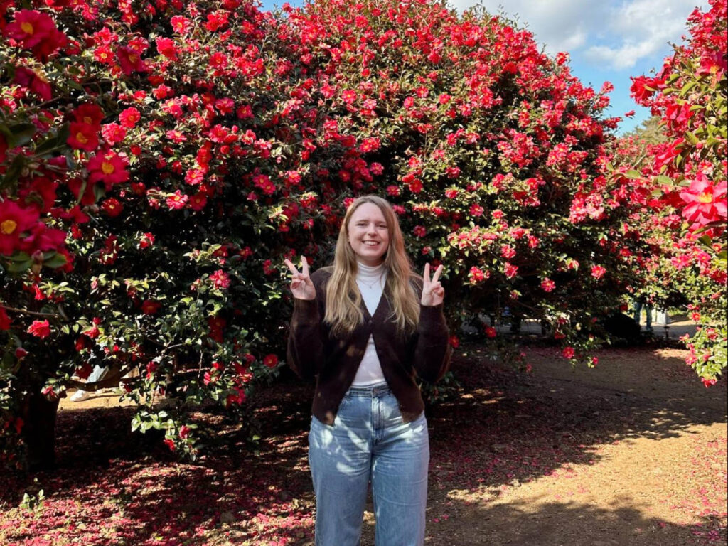 The author, Bethan Nutting posing for a photo at the Camellia Forest, Jeju Island