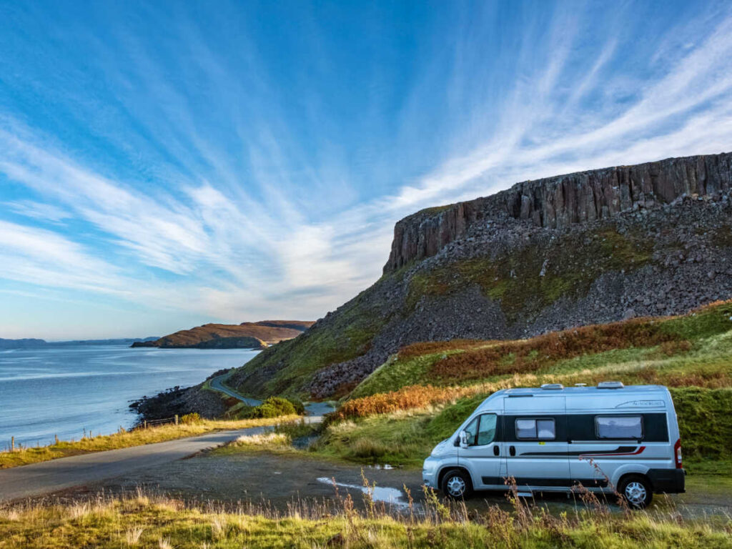 A camper van parked on the Isle of Skye with scenic view around