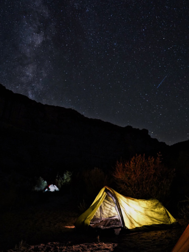 View of camping tent on a campsite at night