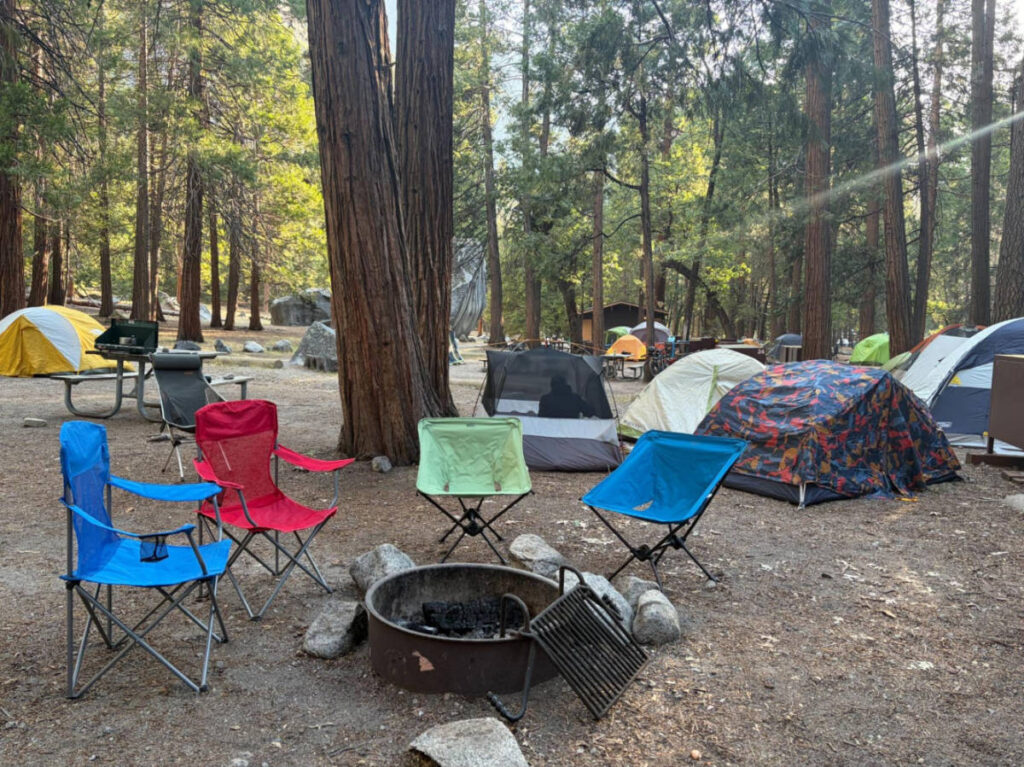 View of the camping tents and chairs around a bonfire at Camp 4 in Yosemite Valley