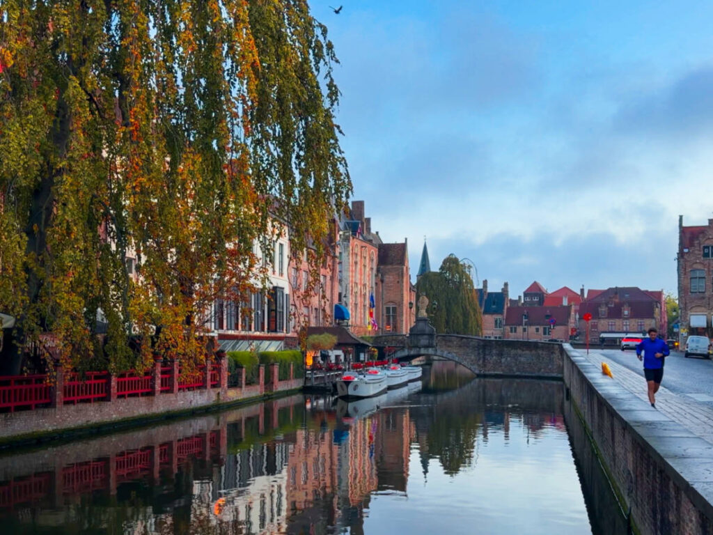 A man running around the canal and architecture of Bruges