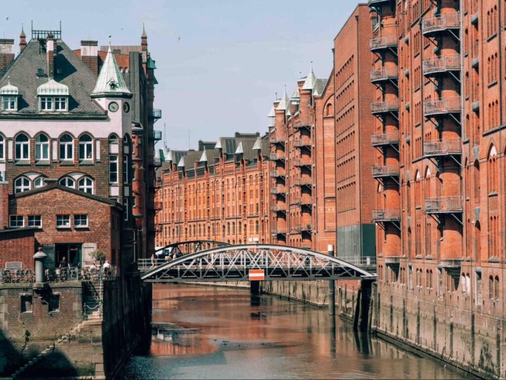 A bridge over the canal surrounded by brick-walled buildings