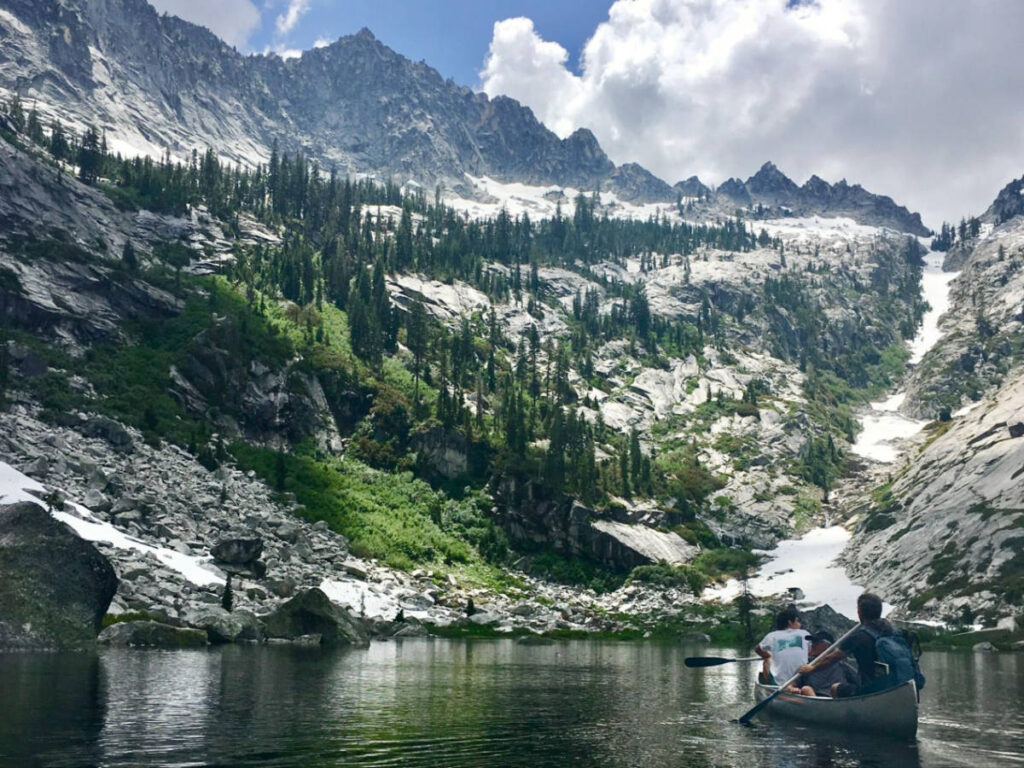 The author's friends canoeing across a lake in the Trinity Alps