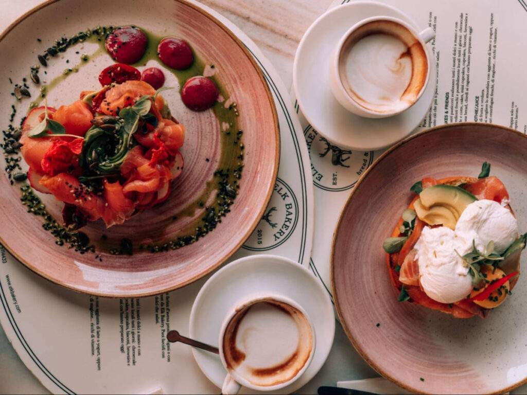 Toast with salmon and avocado with cups of cappuccinos at Elk Bakery
