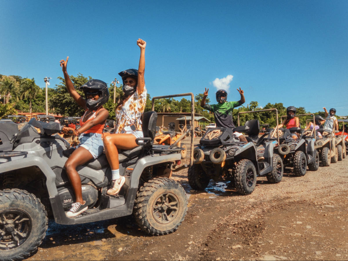 Tourists riding the ATVs in Carabalí Rainforest Adventure Park
