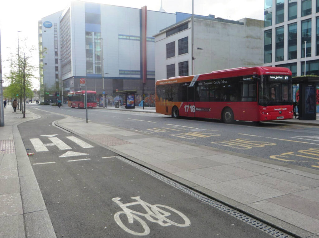 The red buses along the roads in Cardiff