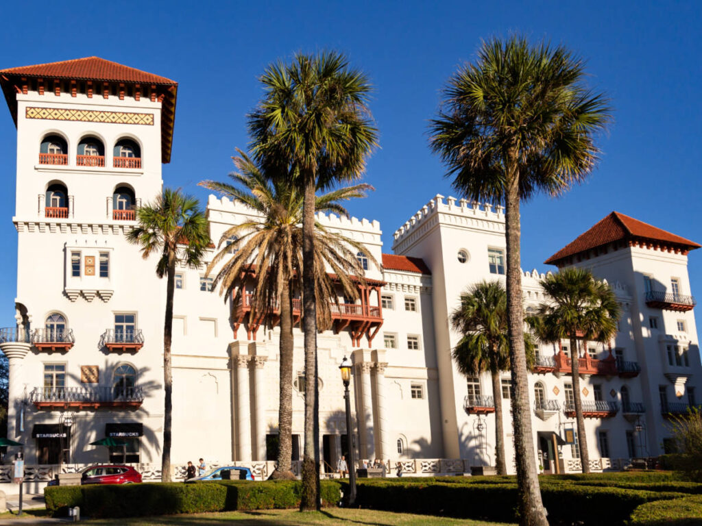 View of the white exterior with red and brown turrets of Casa Monica Resort and Spa