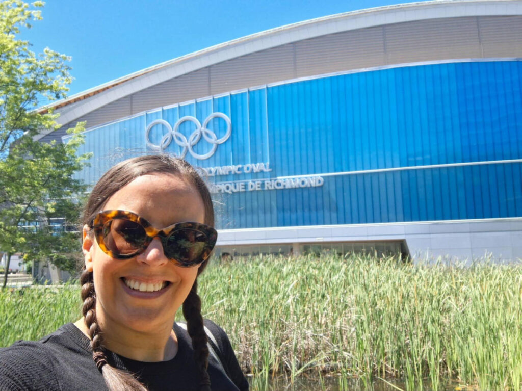 Travel Lemming writer Catherine Driver, smiling for a photo outside the 2010 Winter Olympic Oval