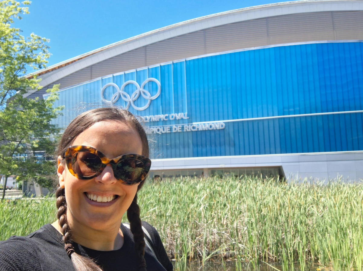 Travel Lemming writer Catherine Driver, smiling for a photo outside the 2010 Winter Olympic Oval