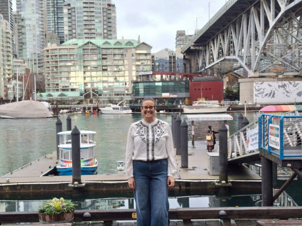 Travel Lemming writer Catherine Driver, smiling for a photo at the Granville Island waterfront