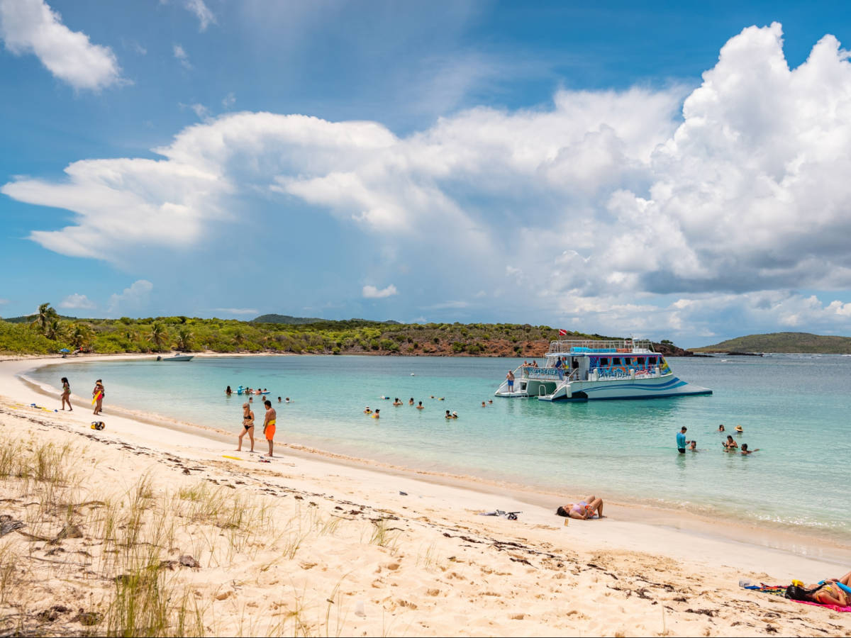 View of the docked catamaran and the people enjoying the beach in Vieques