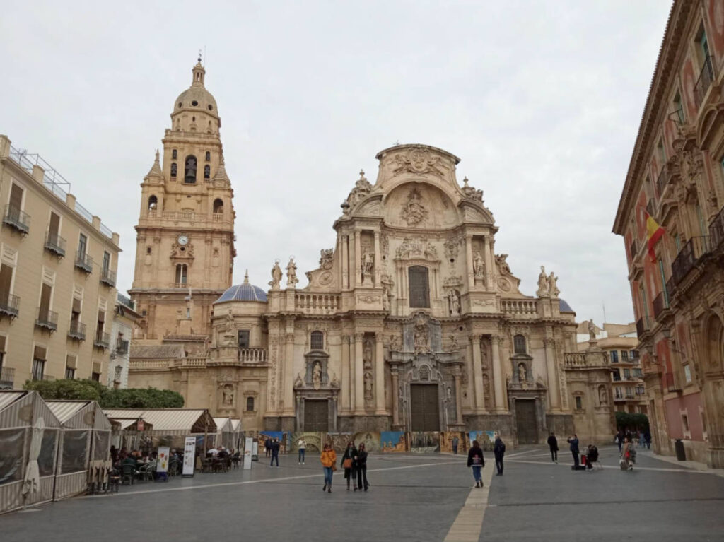 People wandering outside the Cathedral and Plaza del Cardenal Belluga