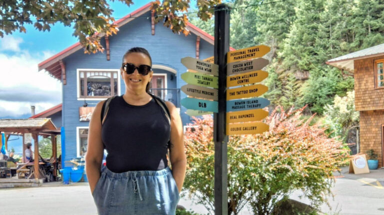 The author Catherine, smiling for a photo at the Artisan Square on Bowen Island