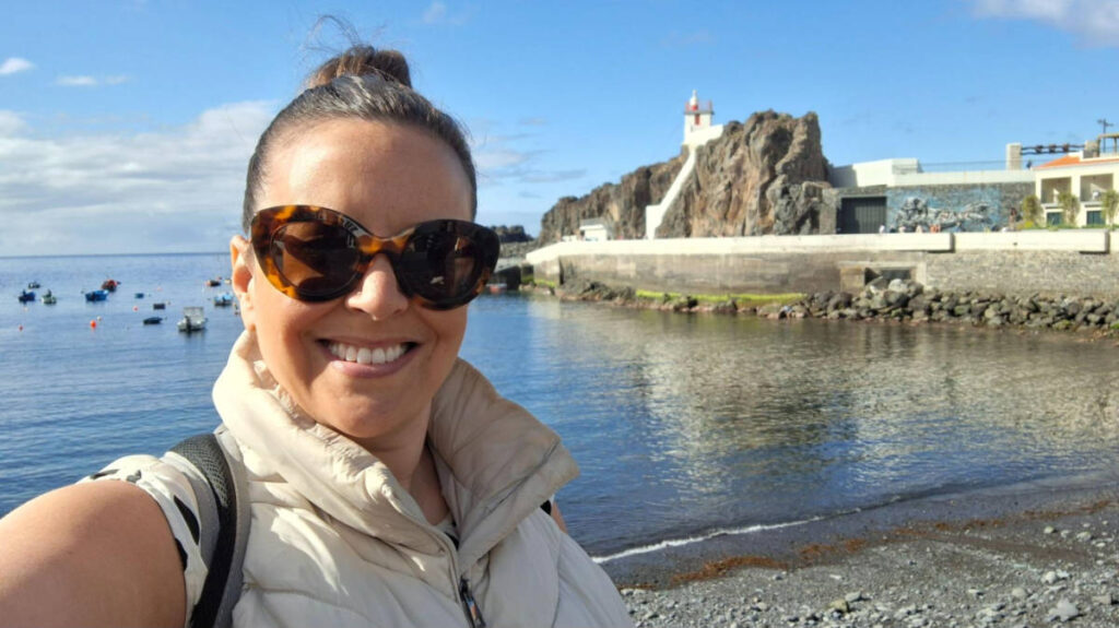 The author Catherine Driver, smiling with the view of Câmara de Lobos