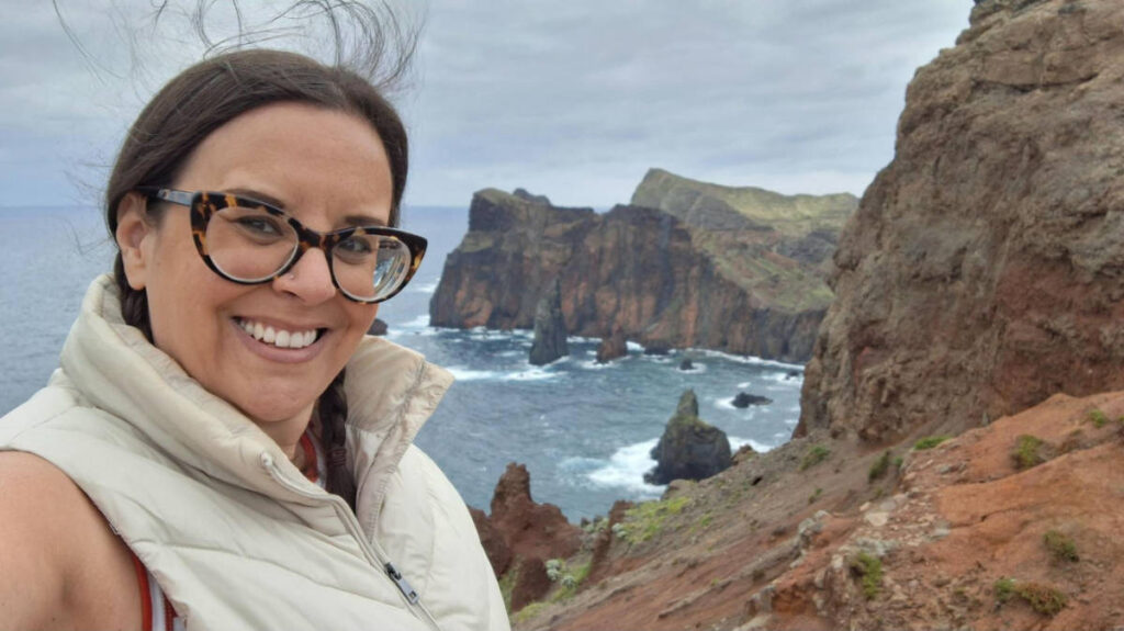 The author Catherine Driver, smiling on a winday day at at Ponta do Rosto