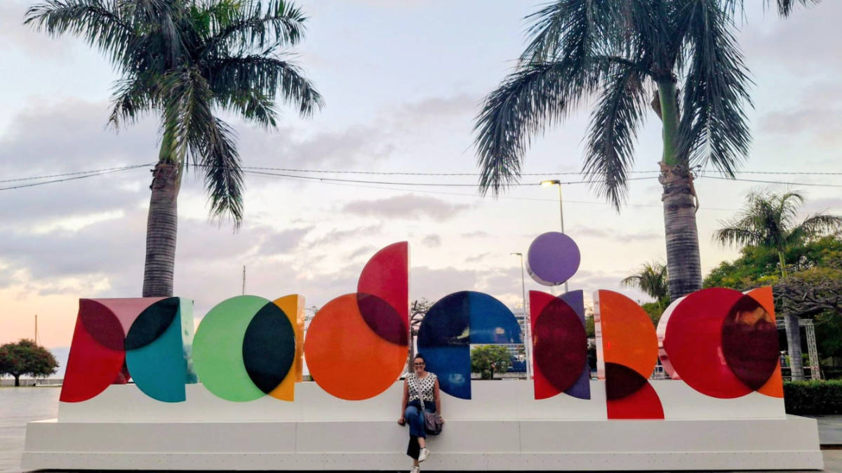 The author Catherine Driver, posing for a photo in front of the iconic Madeira sign