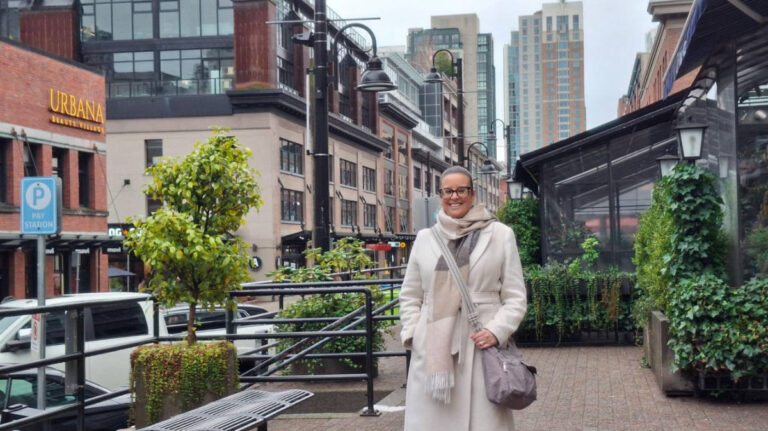 The author Catherine Driver, smiling for a photo in the old warehouse district of Yaletown