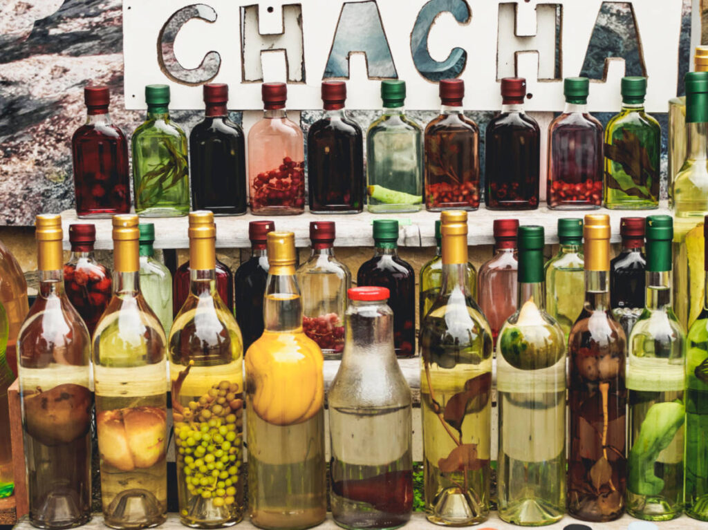 View of the bottles of alcoholic drink chacha with fruit and herbs in Georgia
