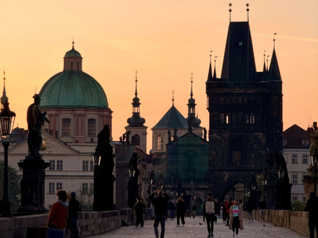 People gather at the Charles Bridge to see the sunrise