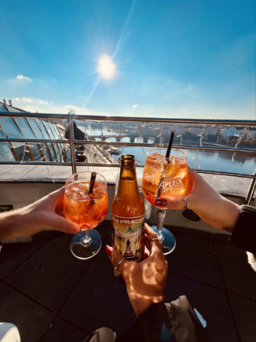 Clinking glasses of drinks at the Glass Bar