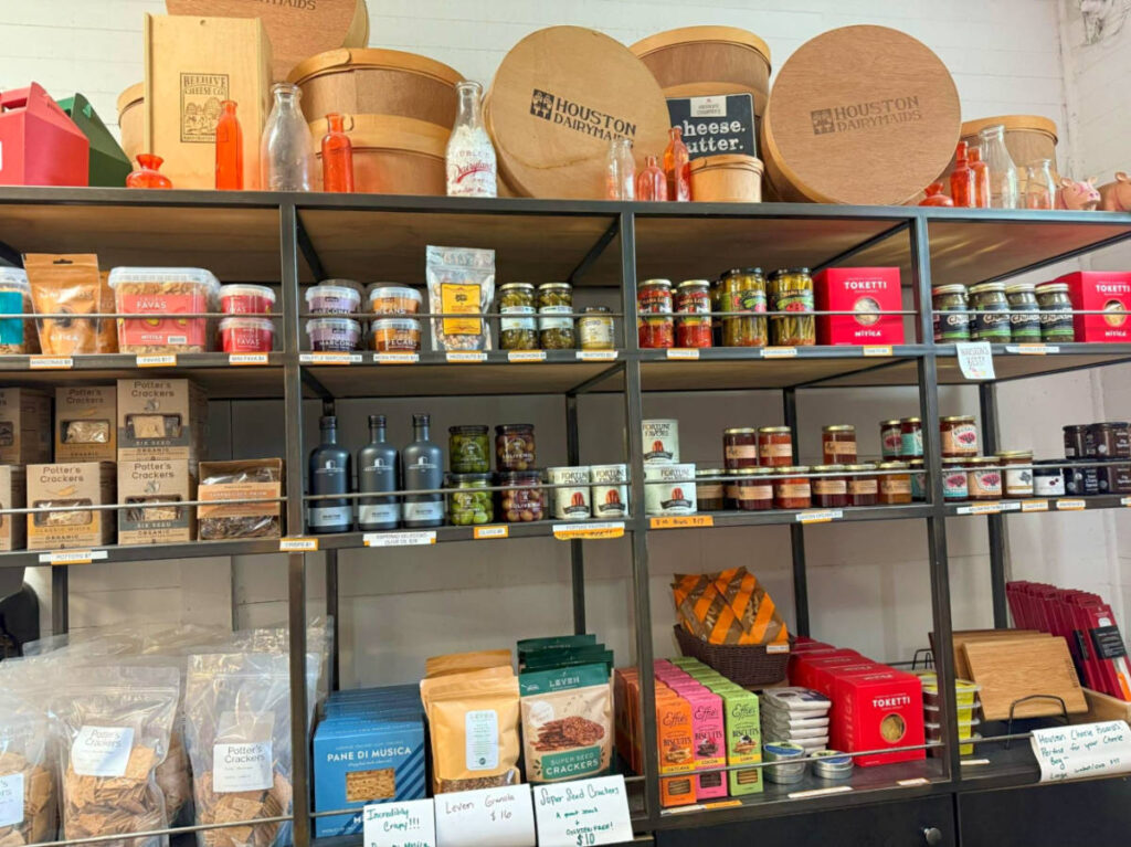 A display rack full of cheese, wines and snacks at Houston Dairymaids
