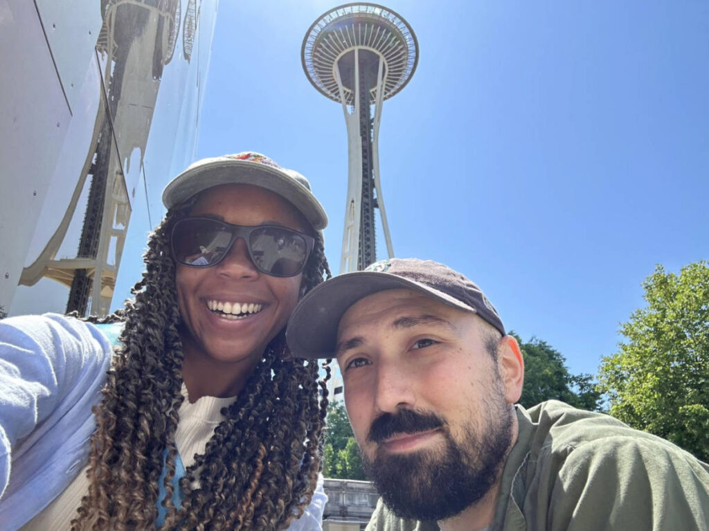 The author Chelsea Booker with her husband taking a selfie at the Seattle Center