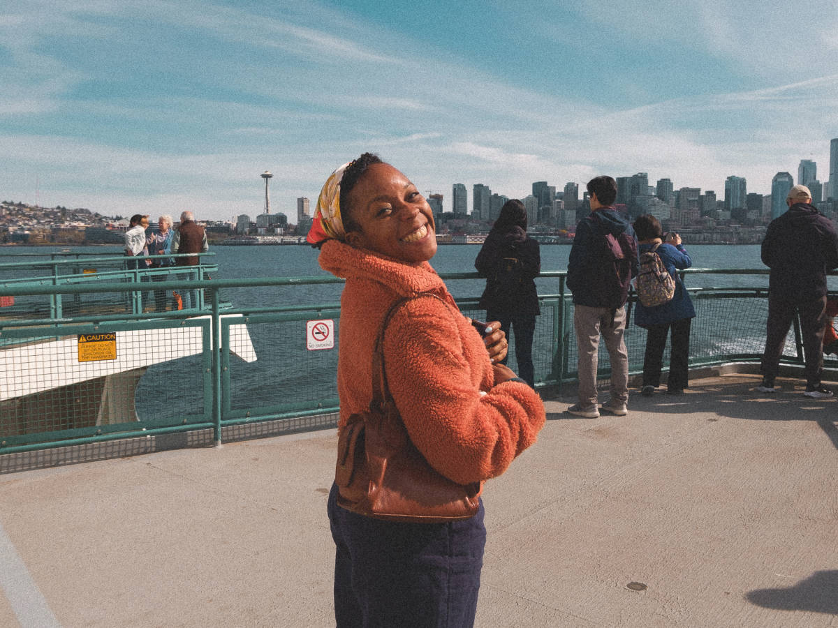 The author, Chelsea Booker smiling for a photo on the ferry to Bainbridge Island