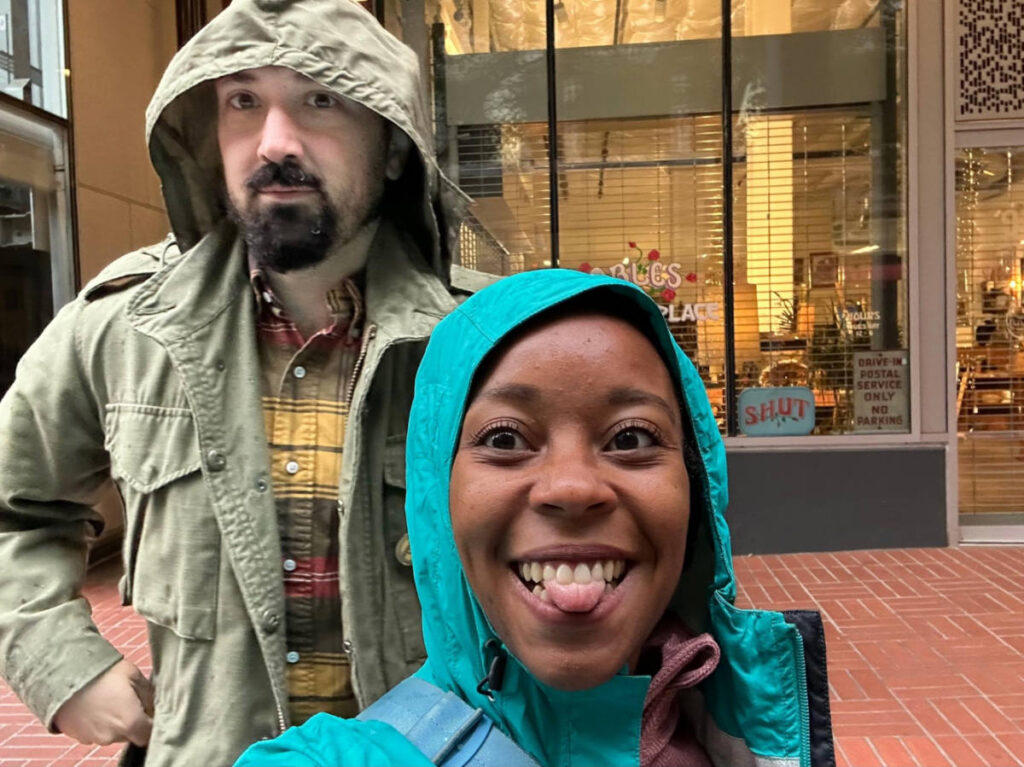 The author Chelsea Booker and her husband, wearing rain jackets on a drizzly morning in Portland