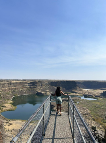 The author Chelsea Booker enjoying the overlooking view of Sun Lakes-Dry Falls State Park at the viewpoint