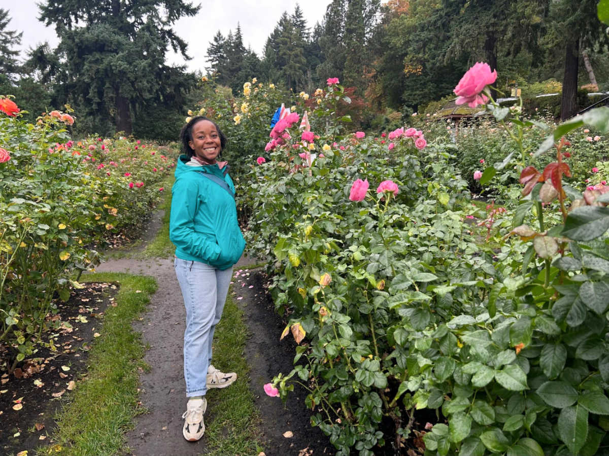 The author Chelsea Booker, enjoying the blooming flowers at the International Rose Test Garden