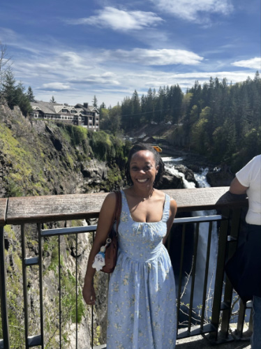 The author Chelsea Booker, smiling for a photo at the viewpoint of Snoqualmie Falls