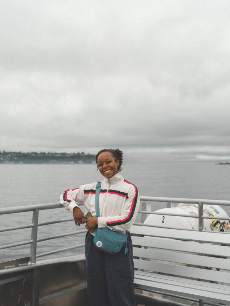 The author Chelsea Booker, smiling for a photo while on the cruise in Seattle