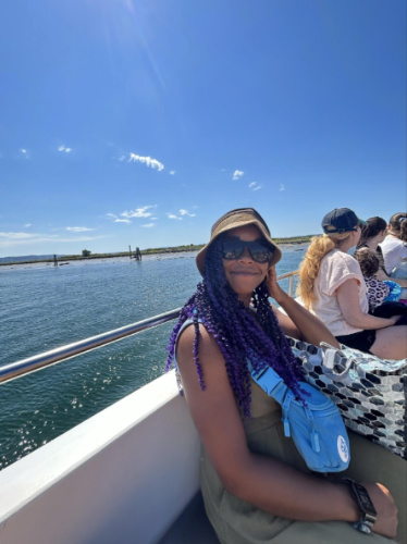 The author Chelsea Booker smiling for a photo while on the ferry to Jetty Island