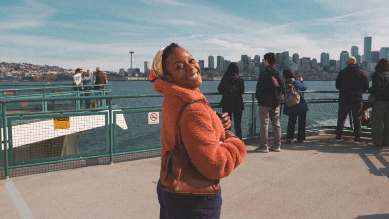The author, Chelsea Booker smiling for a photo on the ferry to Bainbridge Island