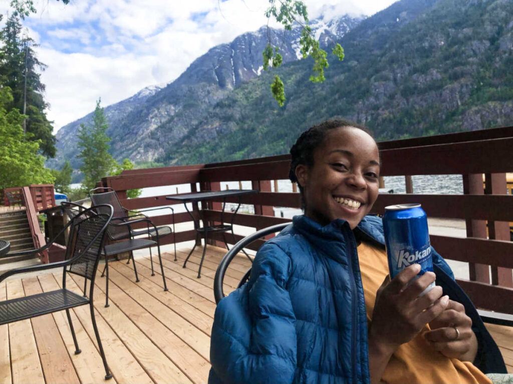 The author Chelsea Booker holding a can of beer
