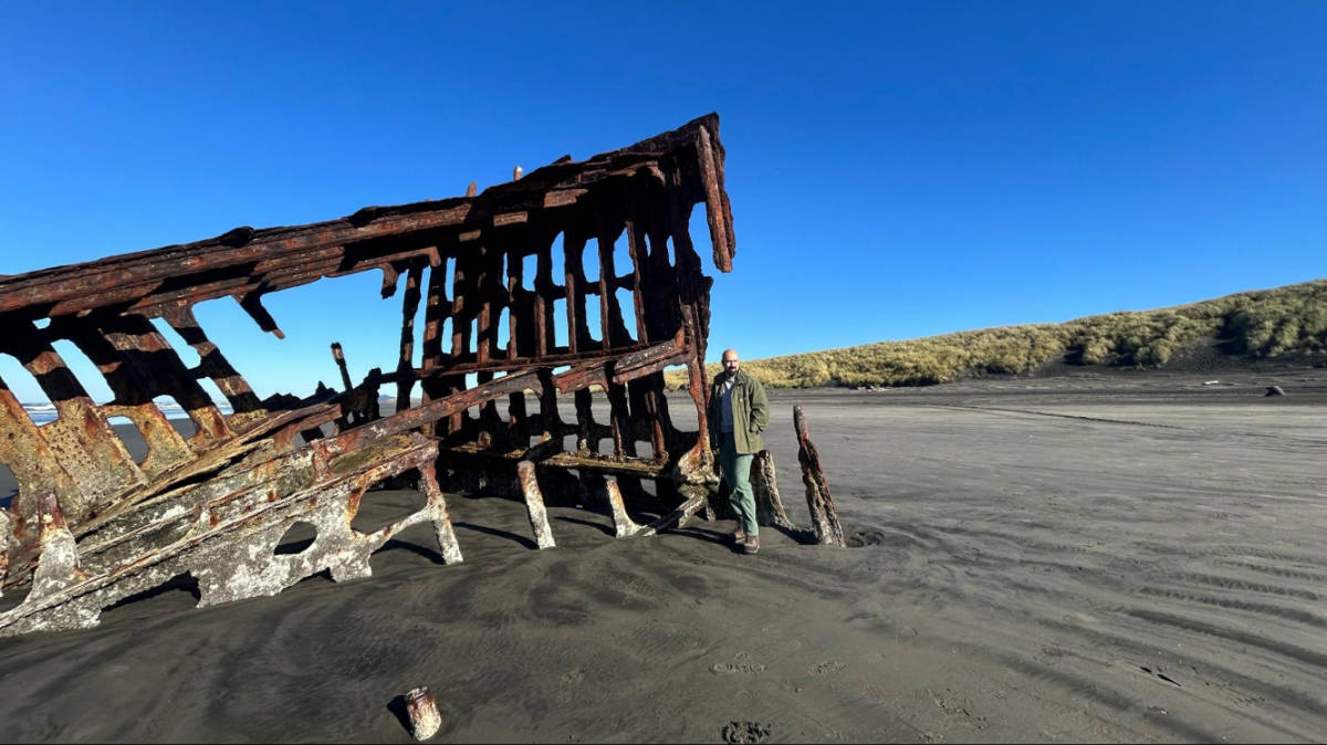 The author's husband, standing near the Peter Iredale Shipwreck