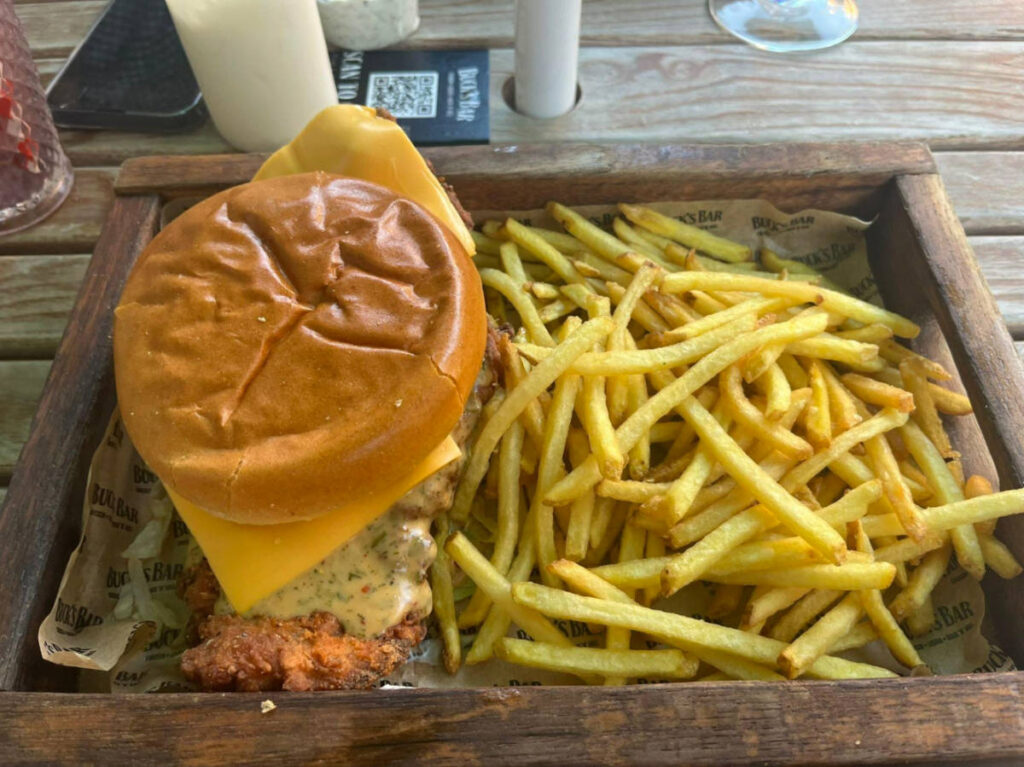 A tray with fried chicken burger and fries from Buck’s Bar
