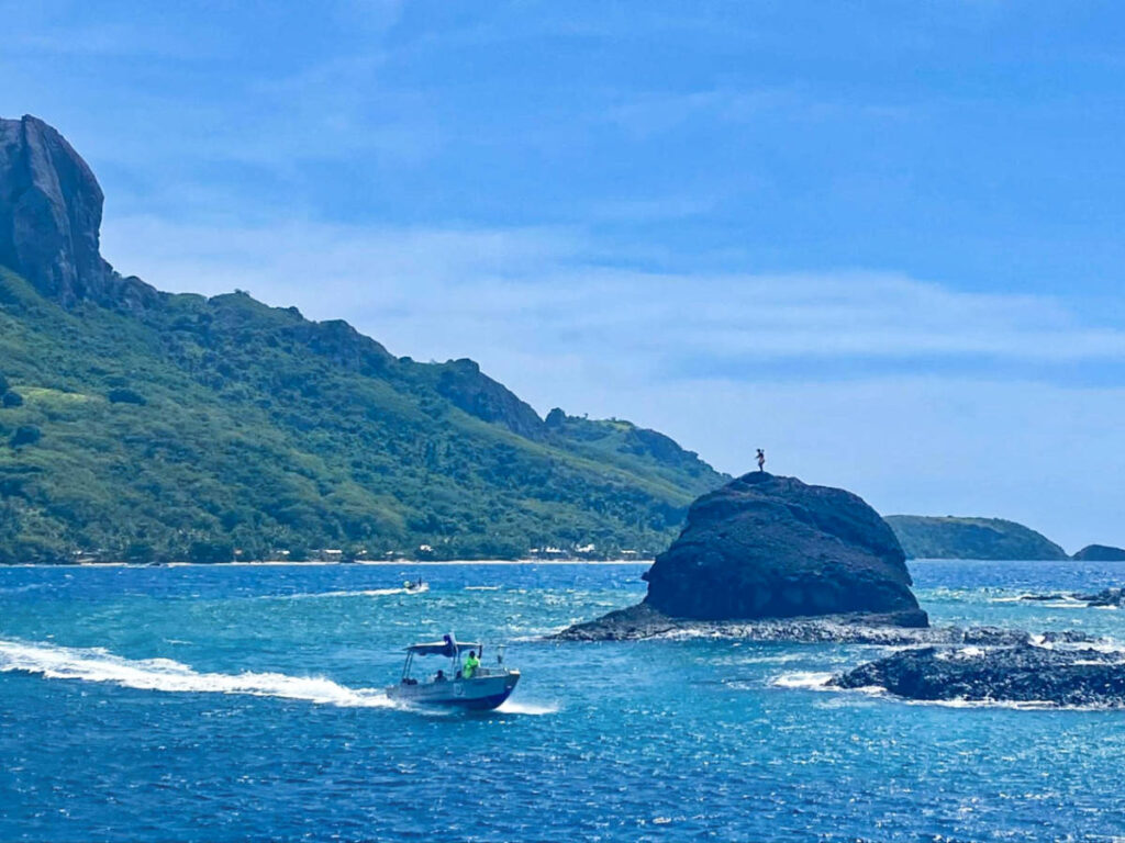 A boat crossing the island chief on the huge rock