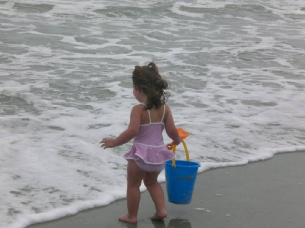 A child playing along the shoreline