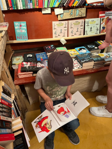 A child reading a book at the Atlantis Books