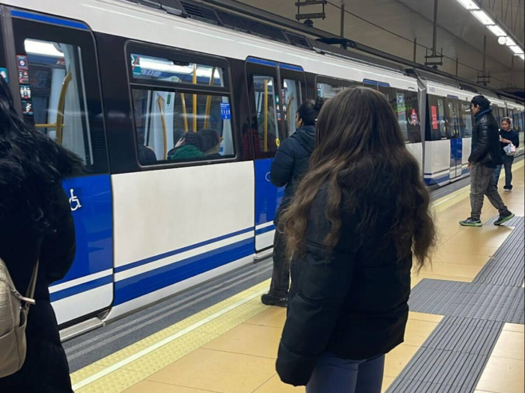The author's daughter, watching the train at the Metro station