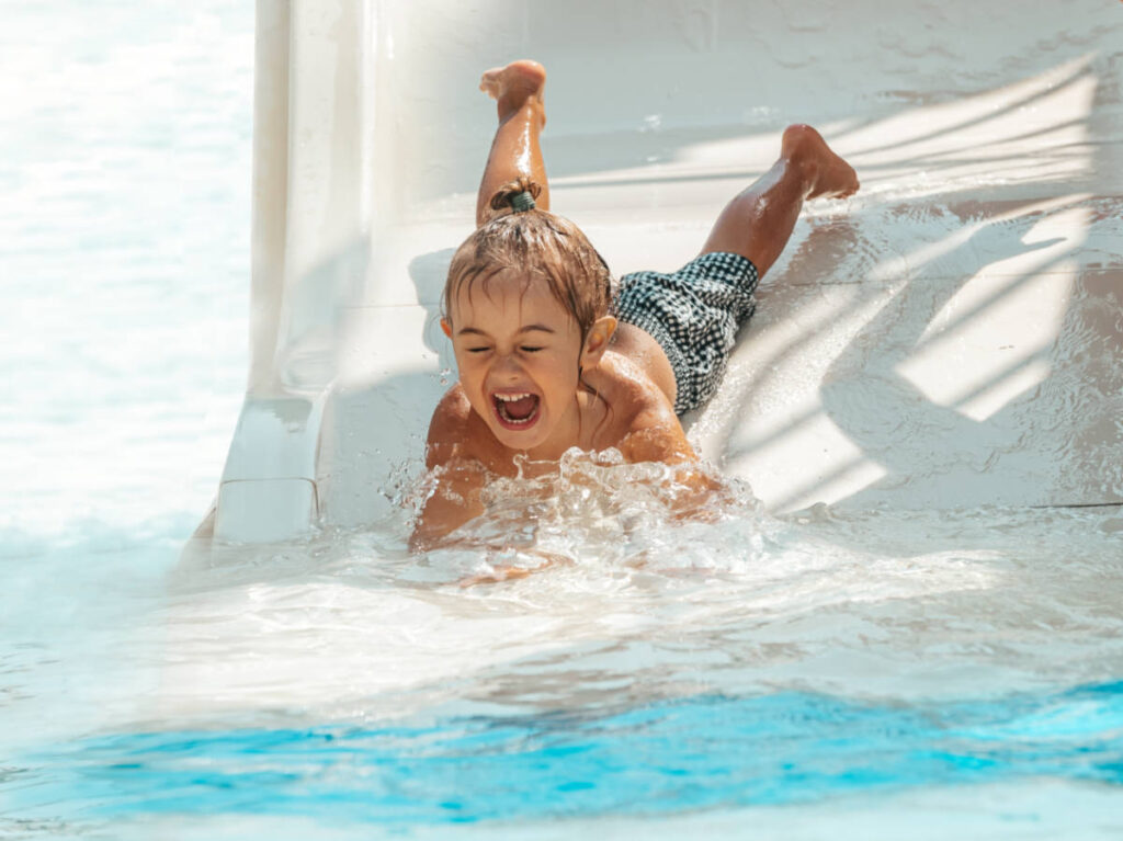 A child enjoying the water slide at the waterpark 