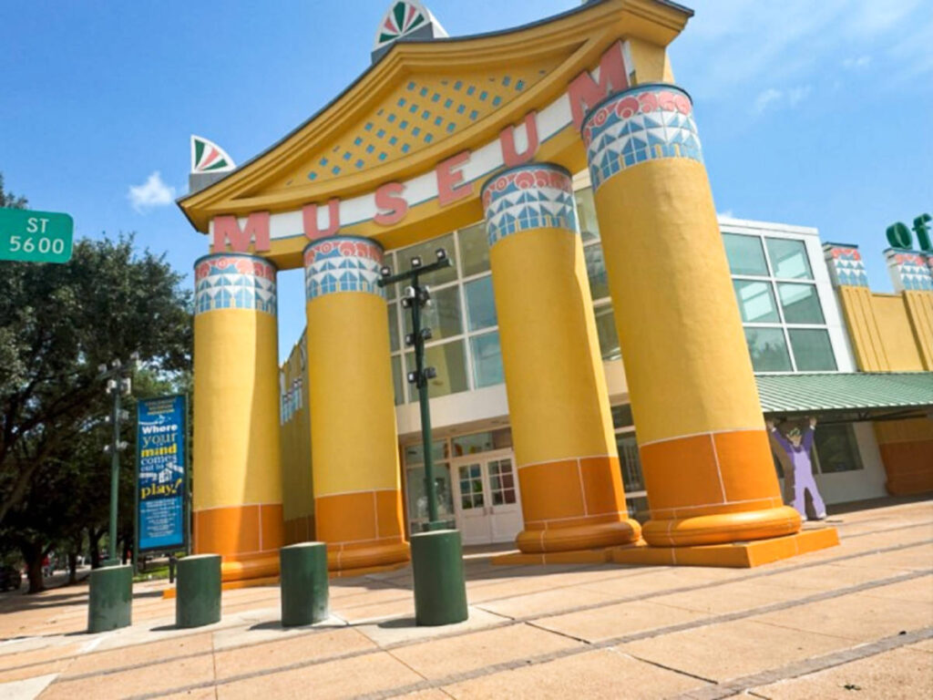 View of the whimsical and vibrant yellow entrance to the Children’s Museum Houston