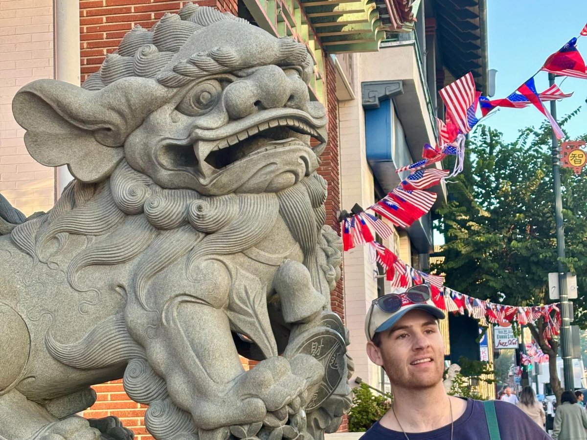 Michael posing for a photo with the Chinatown lion statues