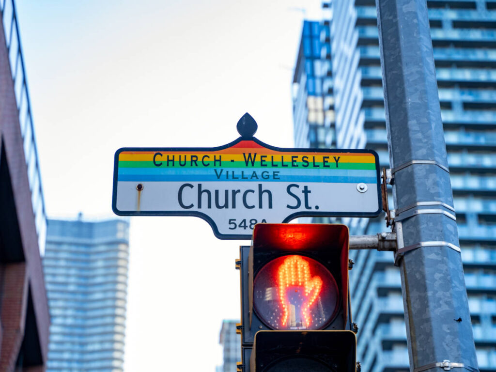 A street sign for Church Street with the rainbow color scheme