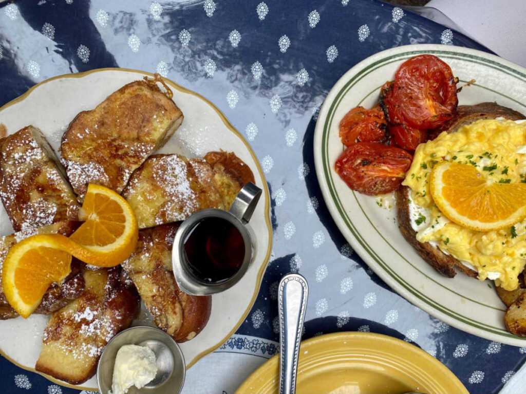 The cinnamon-brioche French toast and the Eggs Lucas, served with goat cheese and roasted tomatoes
