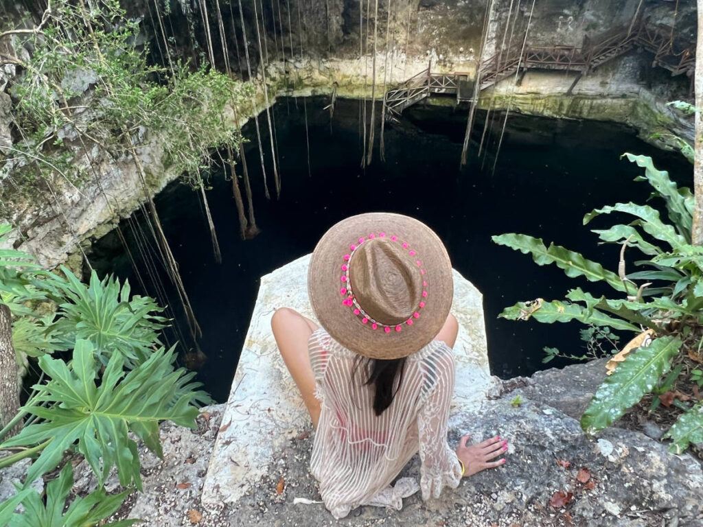 Travel Lemming writer Clara Kesseler, sitting above a cenote