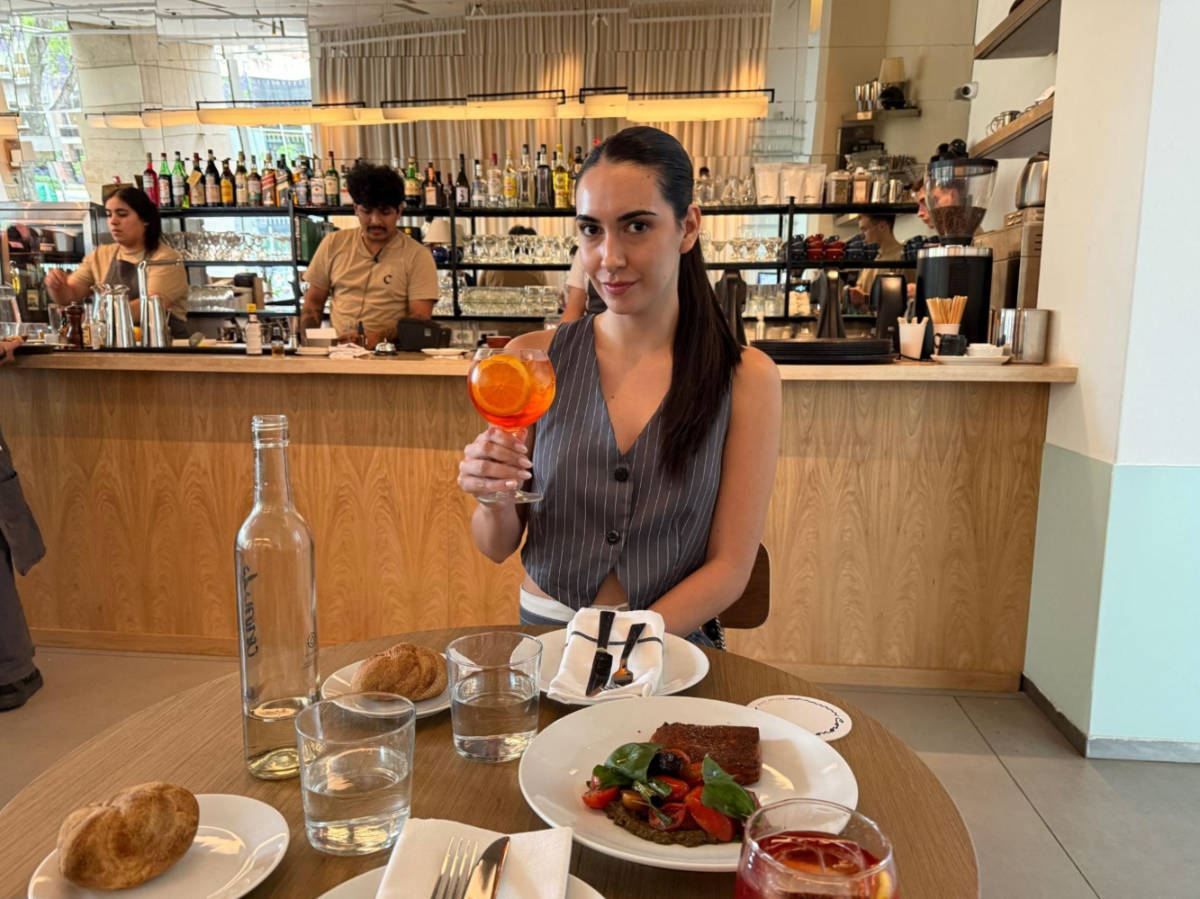 Clara Kesseler holding a glass of drink at MALBA’s Cafe