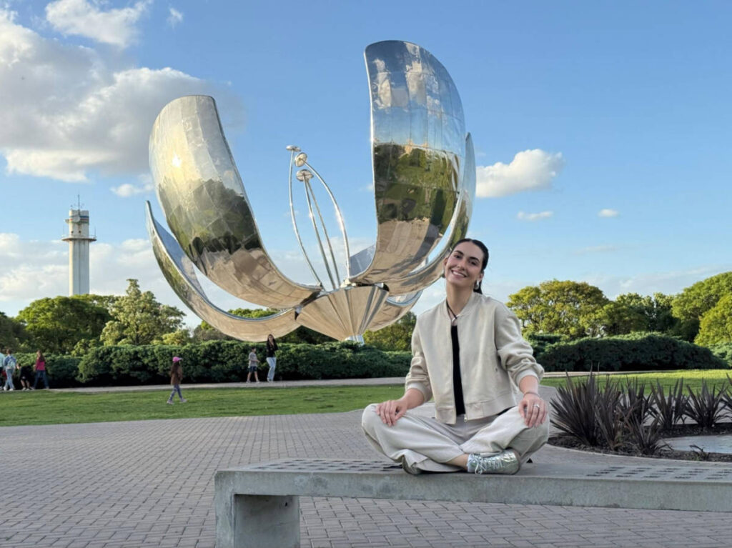Travel Lemming writer Clara Kesseler, sitting on a bench in front of Floralis Generica
