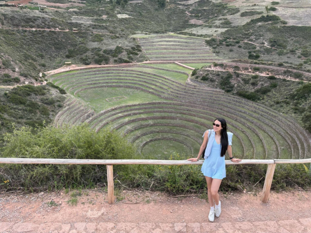 Travel Lemming writer Clara Kessler, posing for a photo with an overlooking of the Moray Archaeological Site